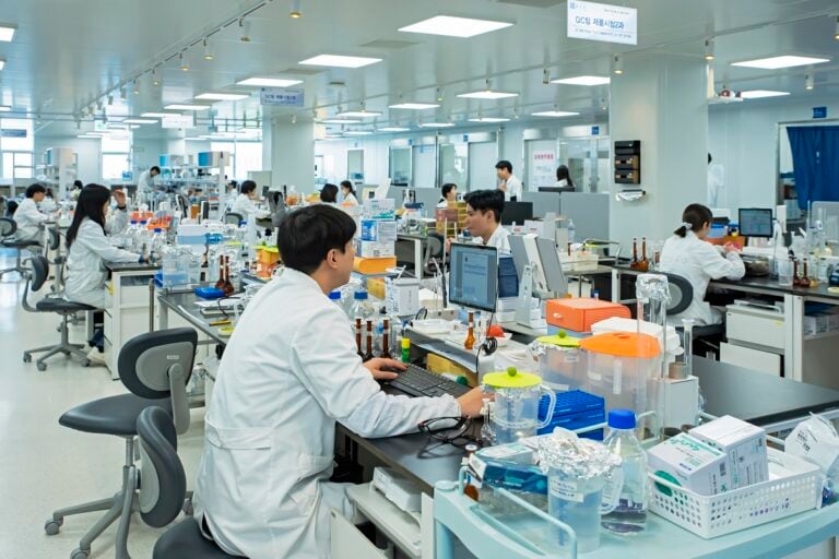 lab technicians and scientist working in lab on computers