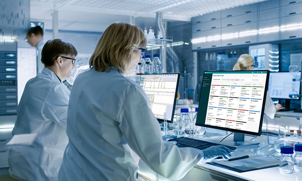 two scientists using empower and data intelligence on monitors full res presentation ready jpg