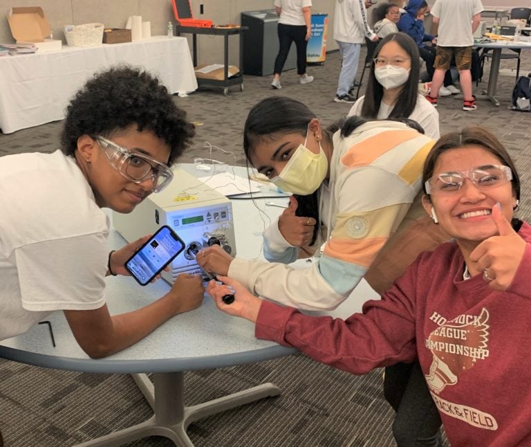 students with smile wearing protective goggles