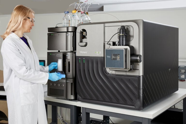 Scientist with Waters Xevo MRT Mass Spectrometer with ACQUITY Premier System.