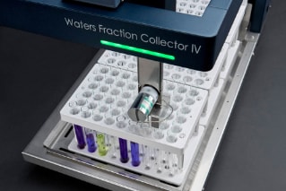 Waters Fraction Collector IV closeup with vials full of colored liquids