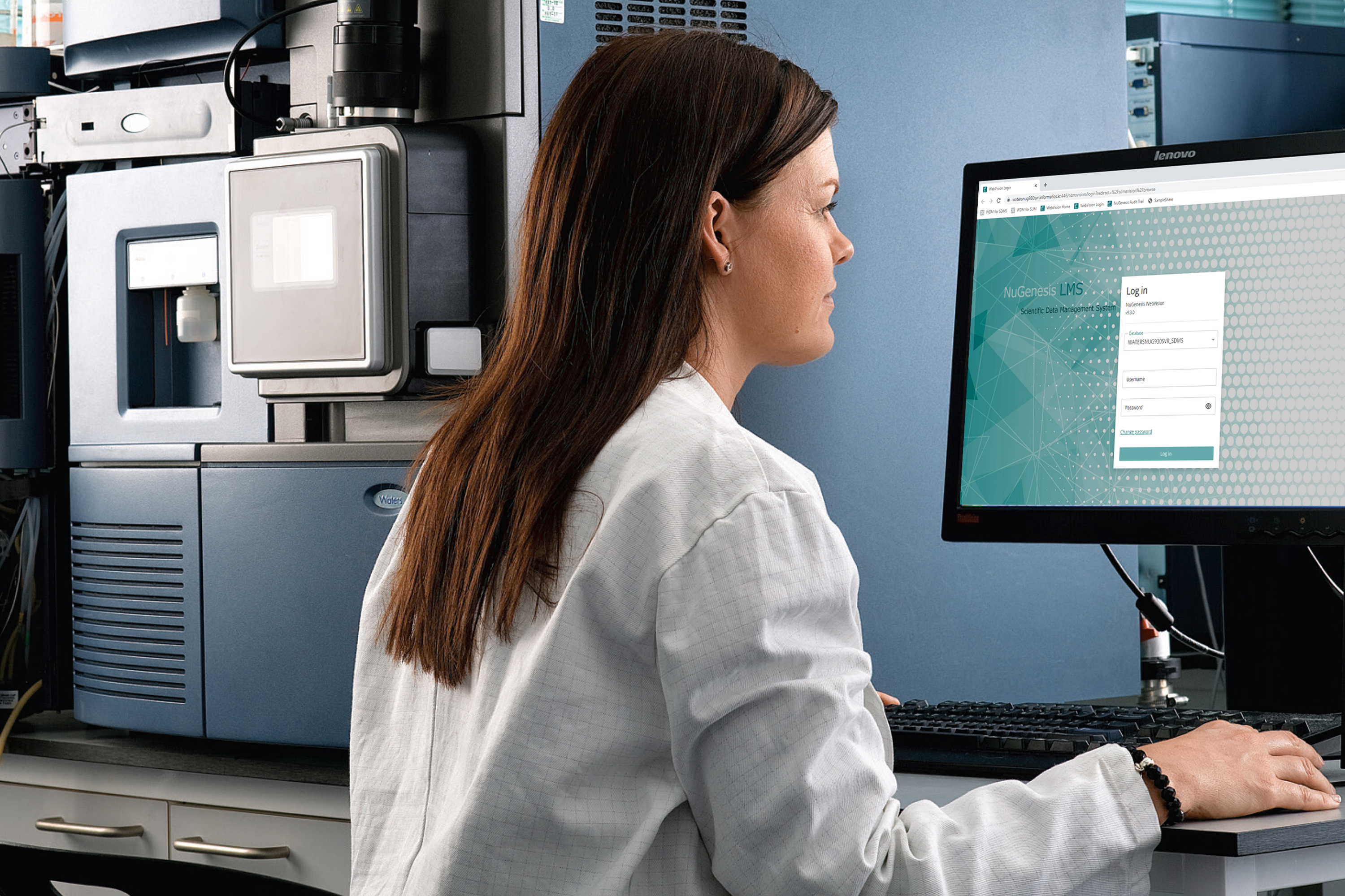 Scientist at a desktop computer looking at upgraded NuGenesis on computer screen.