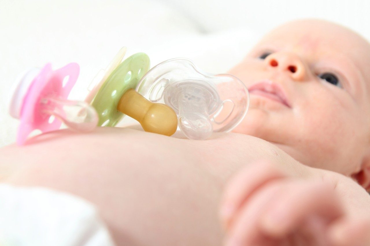 Infant baby with pacifiers