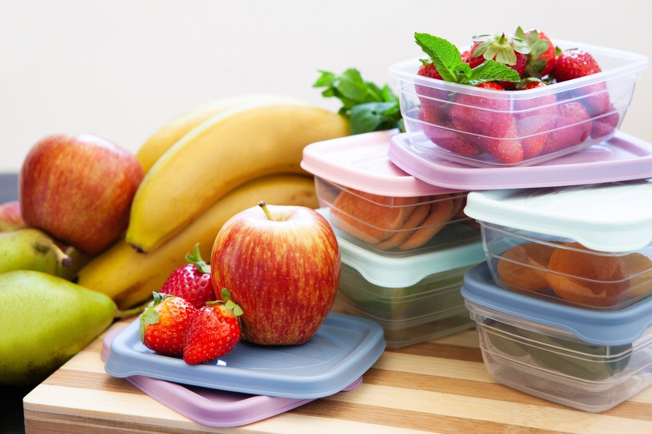Plastic containers and fruits