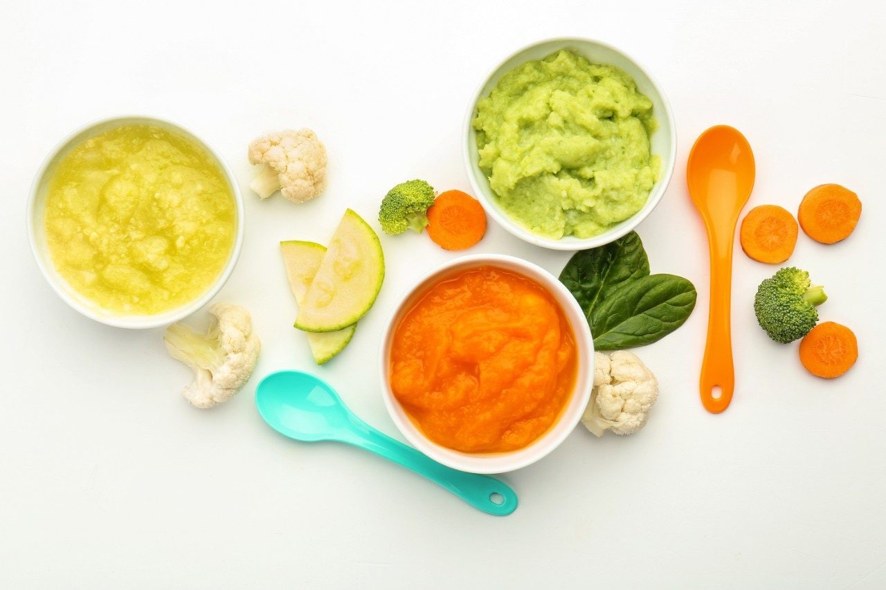 Baby food in bowls with spoons