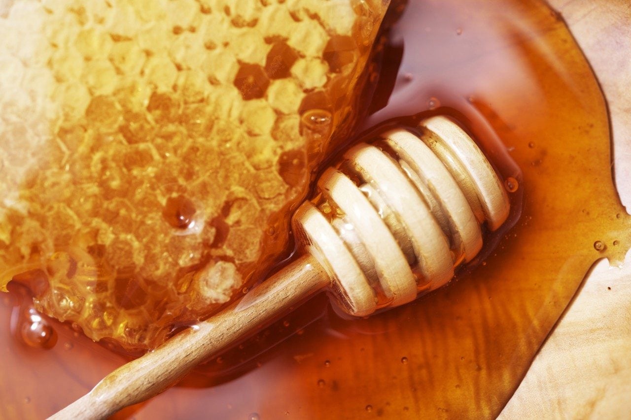 Honeycomb with dipper and raw honey