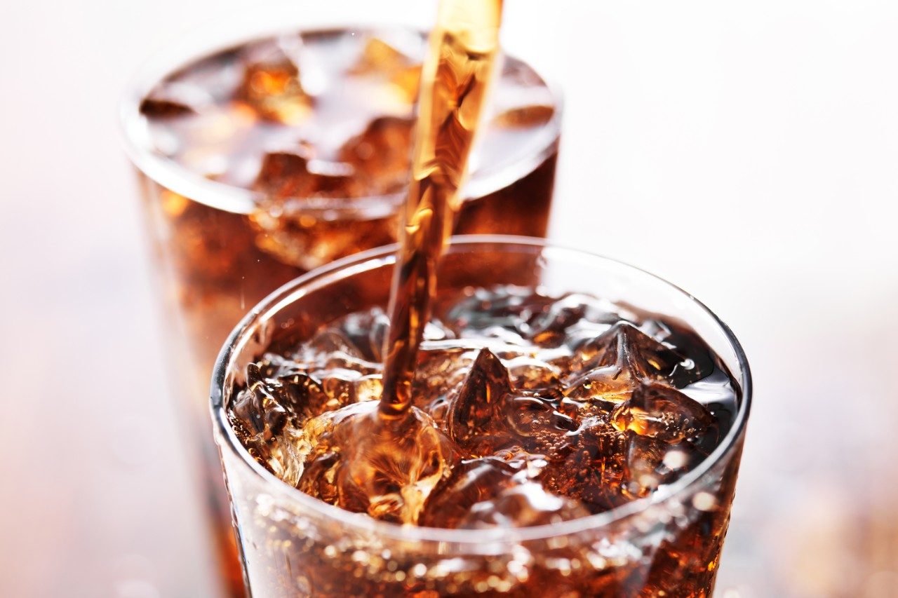 Soft drink being poured into glass
