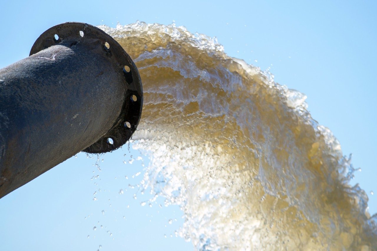 Water flows from a metal pipe