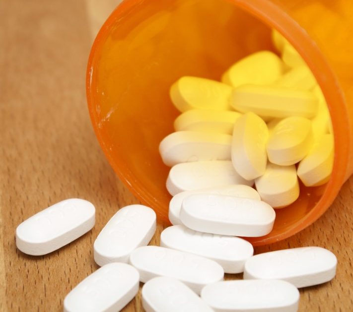Acetaminophen tablets spilling out of bottle