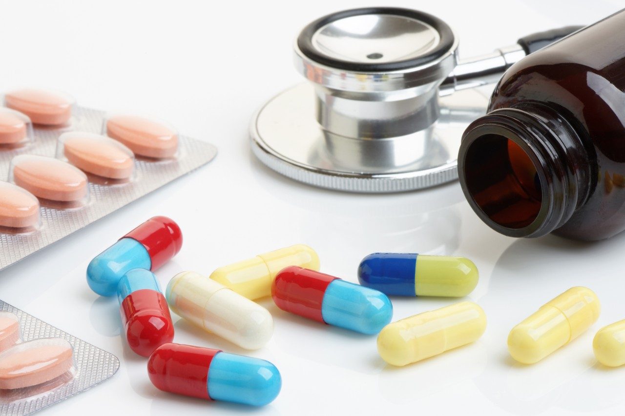 Statin and beta-blocker pills and capsules with bottle and stethoscope