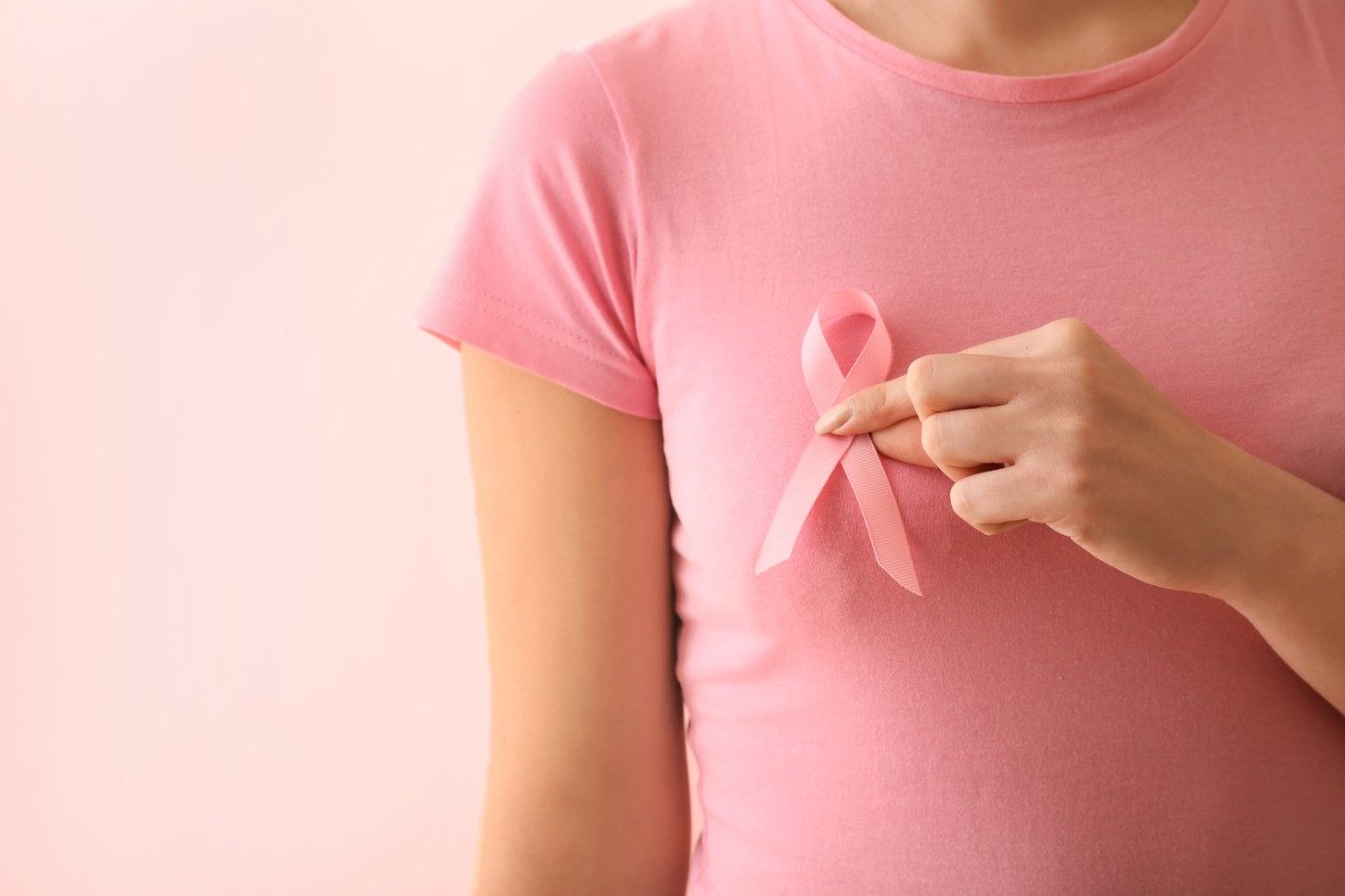 Woman with pink ribbon, breast cancer awareness