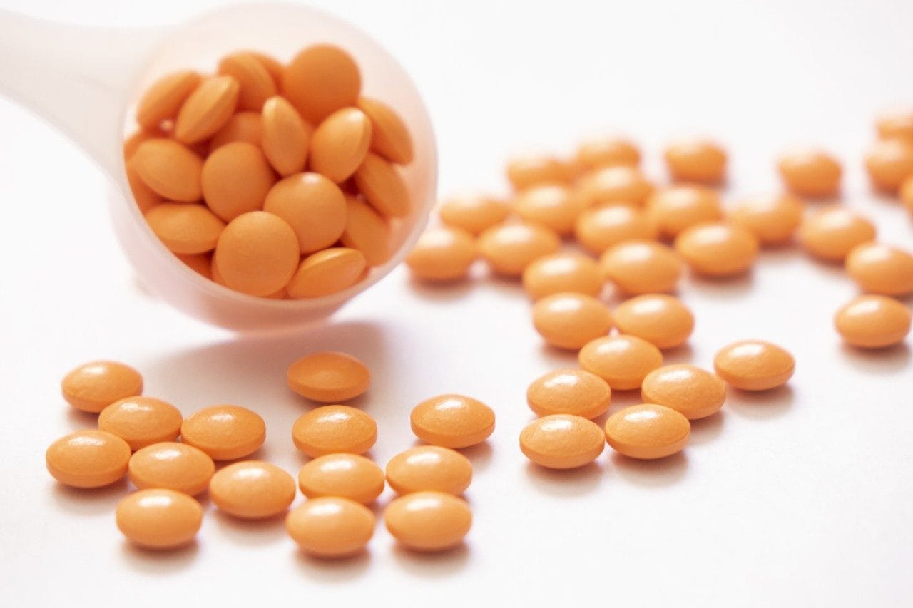 Orange pills on a counting tray