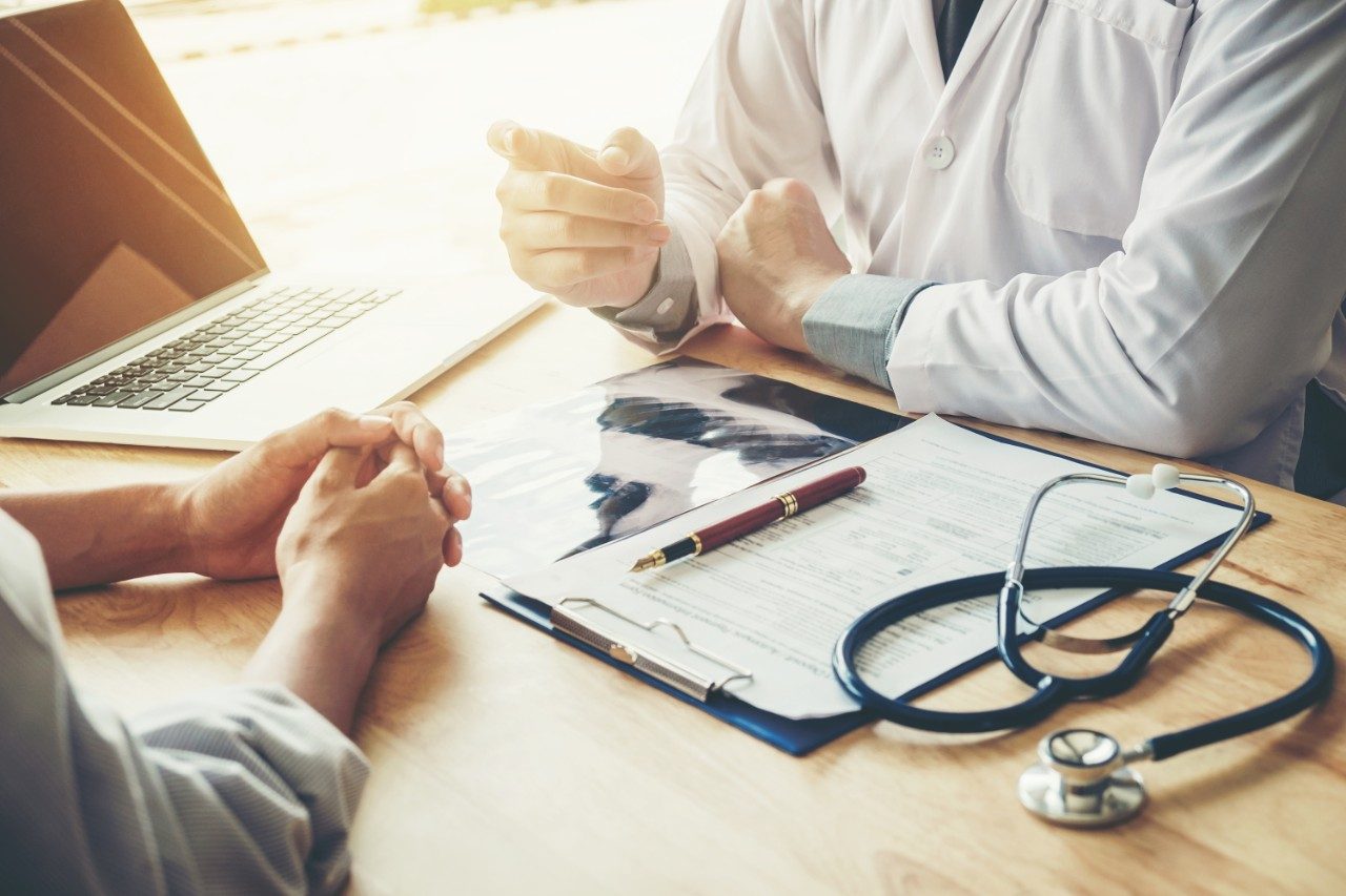 Doctor and patient talking at desk