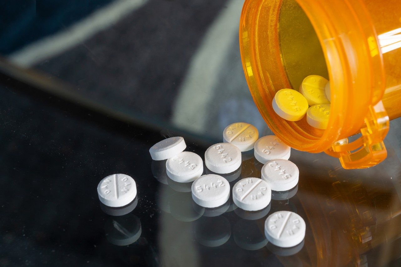 Prednisone pills and bottle pour out on table