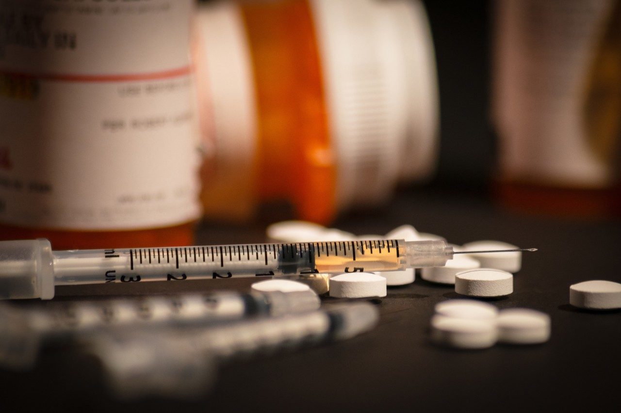 Loaded syringe and pills