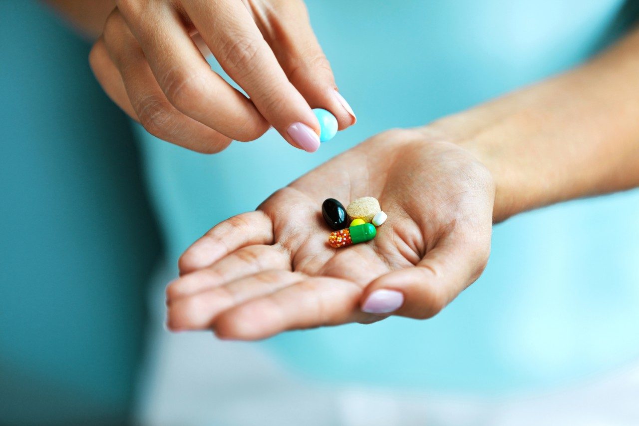 Vitamins and supplements in hand