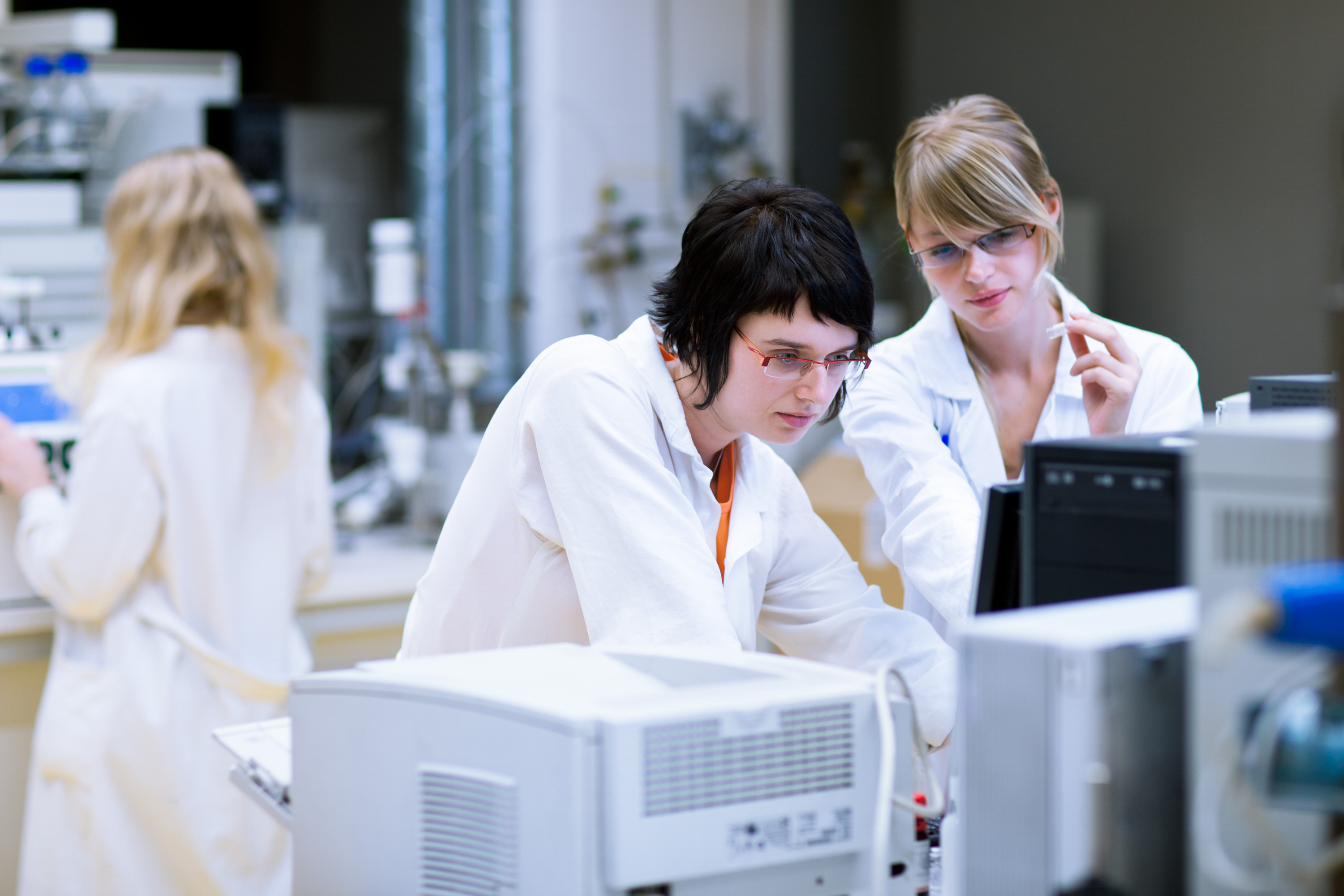 Two female researchers/chemistry students doing research in a chemistry lab