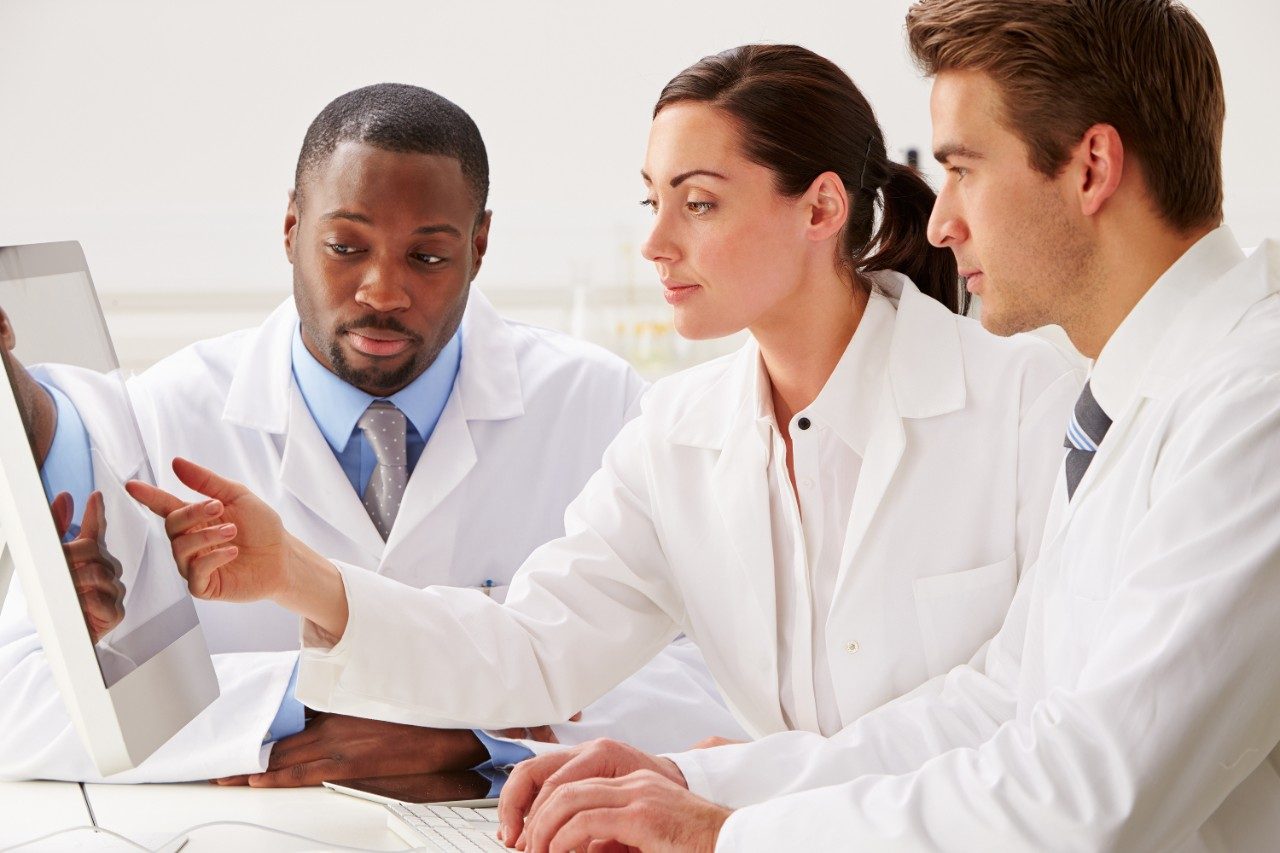 Scientists checking laboratory results on computer