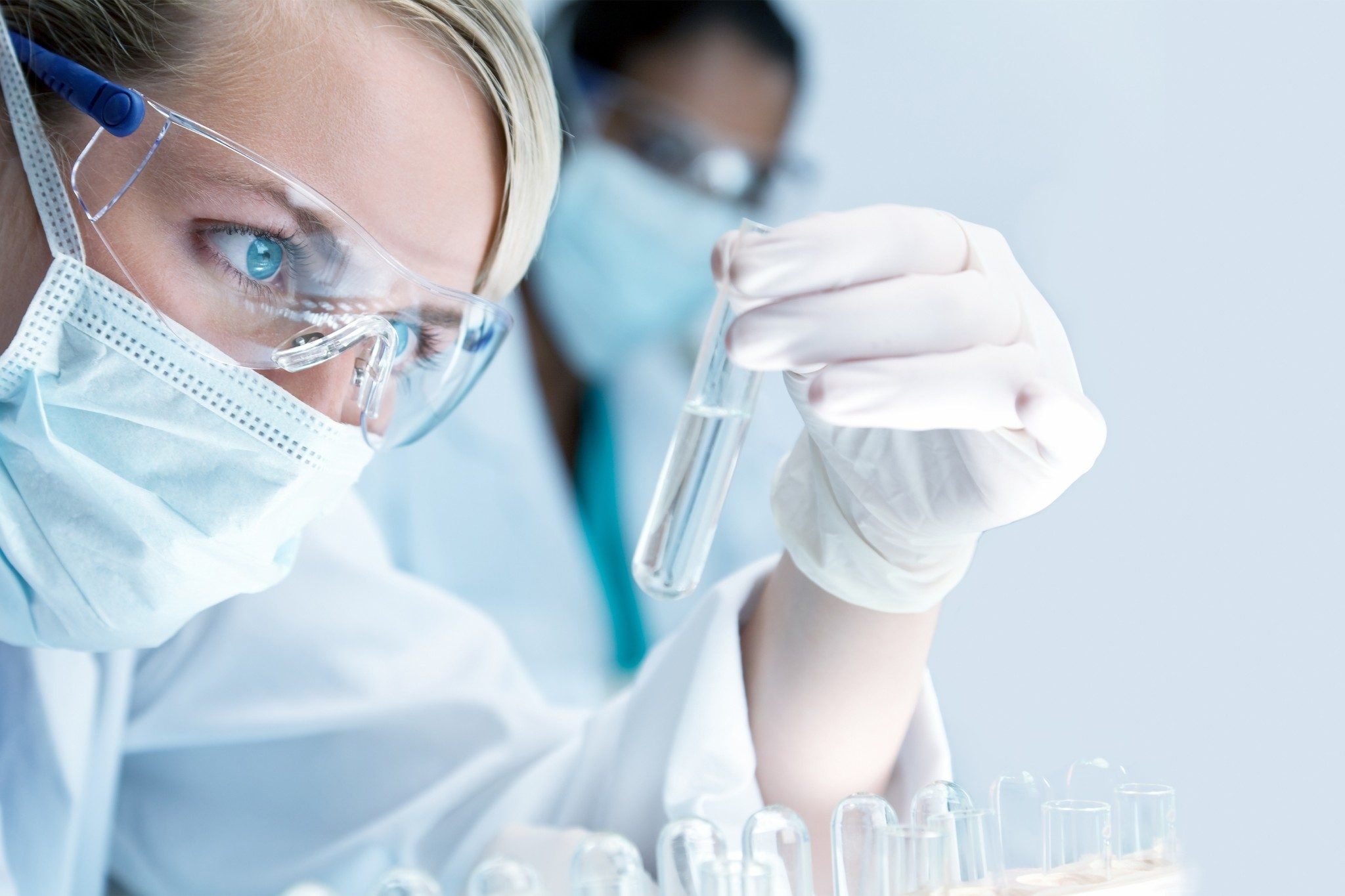 Scientist looking at a glass test tube
