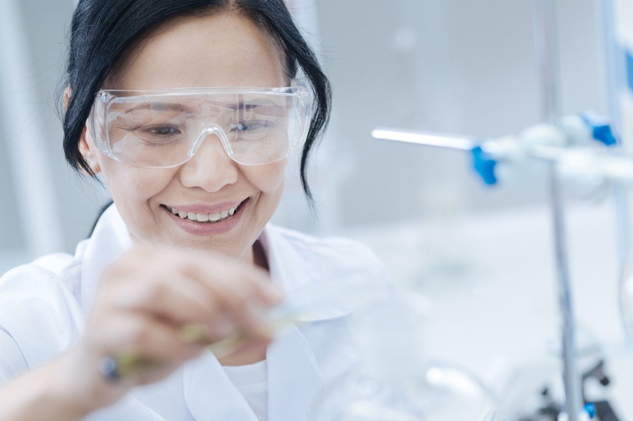 Female scientist smiling in lab