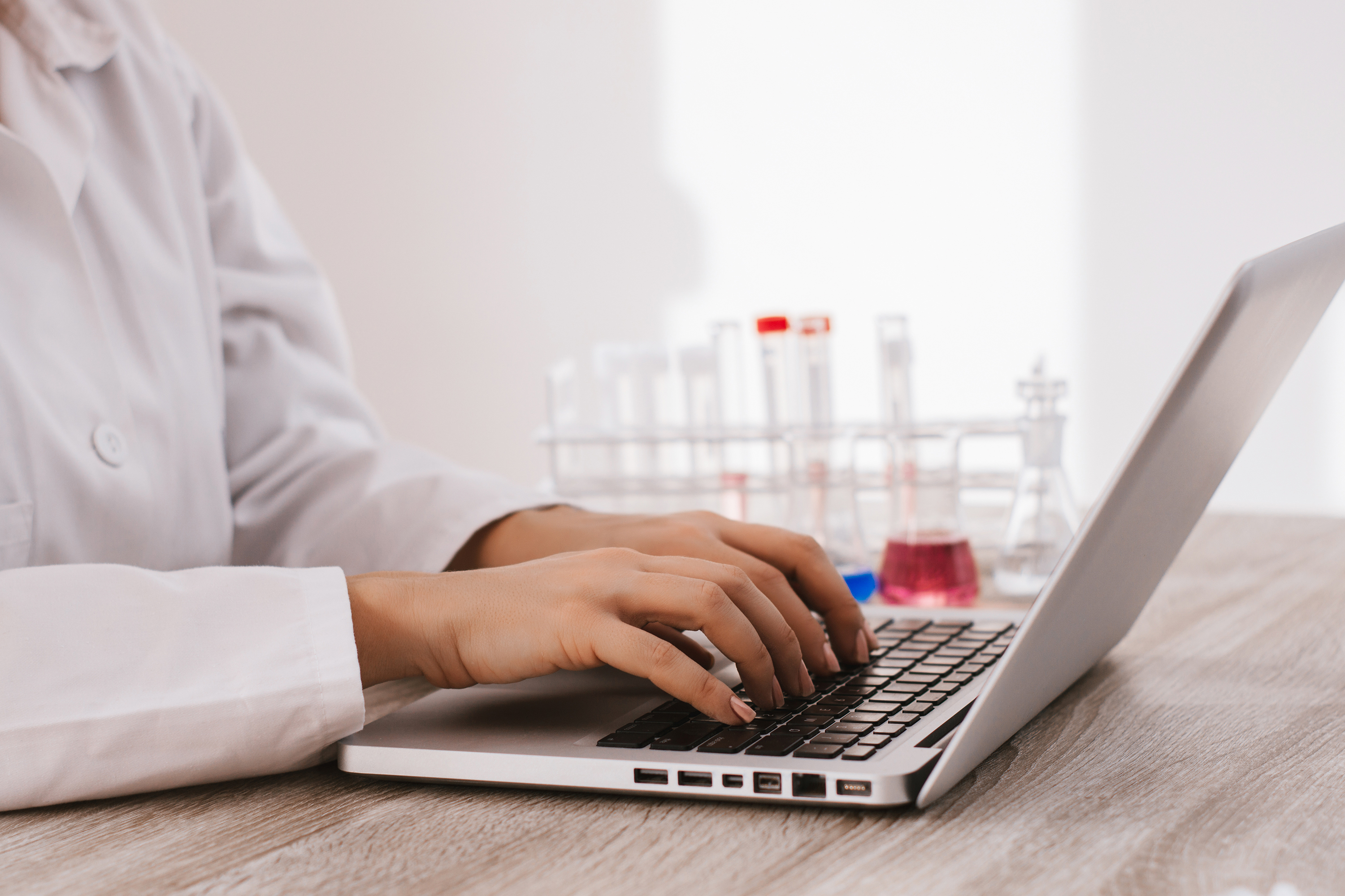 Scientist typing on laptop in the laboratory