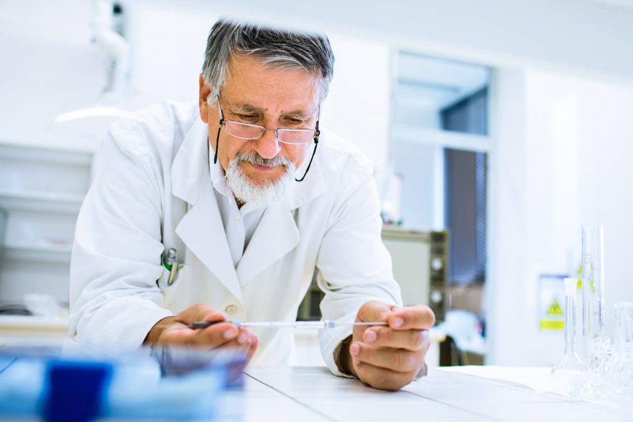 Senior male researcher carrying out scientific research in a lab