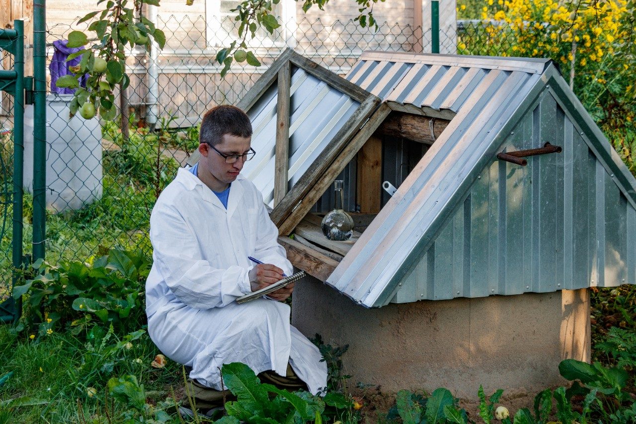 Lab technician analysis of drinking water sample in a well