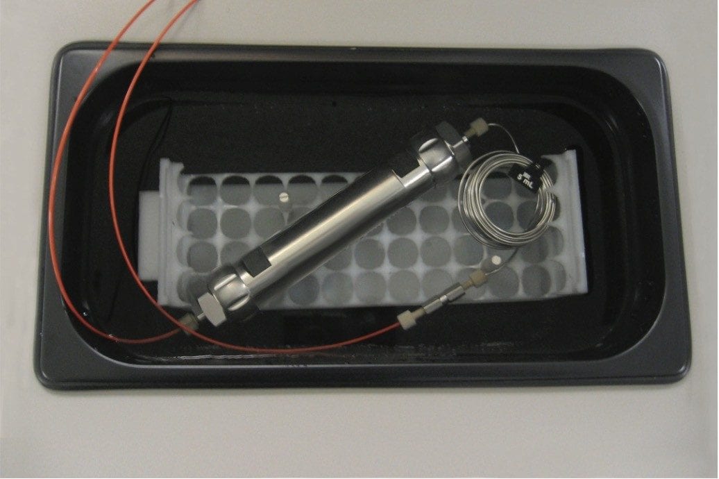 a 5 mL loop plumbed at the head of the column serves as a solvent preheater
